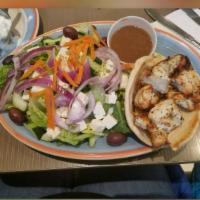 Chicken Souvlaki · Grilled marinated chicken breast chunks on pita bread. Served with tzatziki sauce and  frenc...