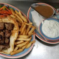 Greek Souvlaki · Marinated chunks of pork on pita  . Served with tzatziki sauce and  french fries with Greek ...