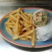 Chicken Caesar Wrap · Grilled chicken, romaine lettuce, grated cheese and croutons in our own Caesar dressing. Ser...