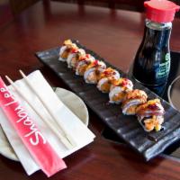 Dragon Maki · Spicy shrimp tempura with avocado, cucumber and tobiko roll topped with thinly sliced eel an...