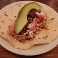 Chicken Taco · Pulled chicken, mole sauce, cotija cheese, pink onions with avocado.