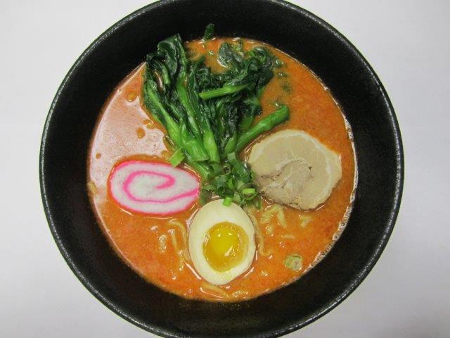 Tan Tan Ramen  · White sesame paste with Sriracha, chili oil, shoyu base in soup with char siu, fish cake, choy sum, green onion, and soft egg. Spicy. 