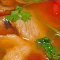 Tom Yum Soup · Hot and sour lemon grass broth with lime juice, tomatoes, and mushrooms.