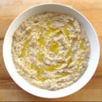 Baba Ghanouj · Eggplant grilled and mixed with sesame sauce, lemon juice and garlic with olive oil.