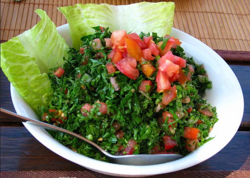 Tabbouli Salad · Fresh curly parsley, tomatoes, dry mint leaves, cracked wheat, tossed in lemon juice and olive oil.