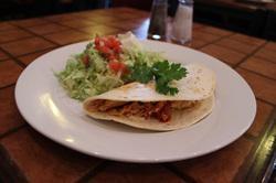 Quesadilla Dinner · Choice of grilled steak or grilled chicken inside a hot pressed tortilla topped with jalapeno cheese sauce and served with rice, refried beans.