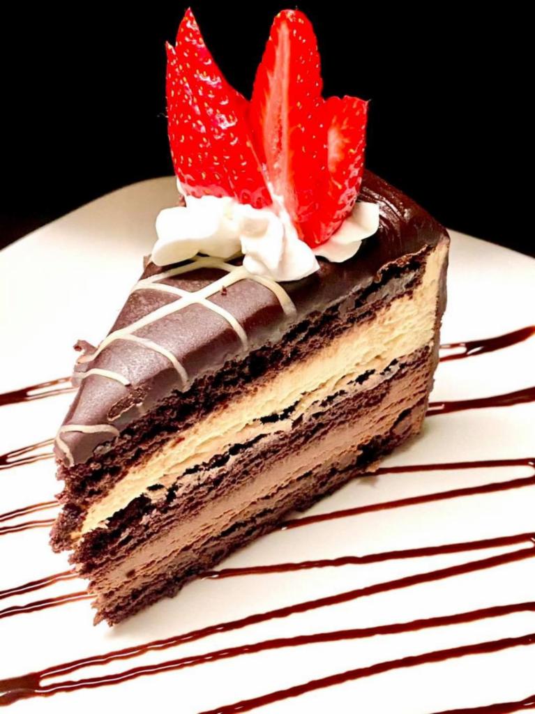Chocolate Mousse Cake  · Decadent layers of dark and white chocolate mousse cake topped with shaved chocolate 
