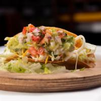 Chicken Hard Shell Taco · Delicious chicken among freshly prepared ingredients served in a crisp-fried corn tortilla. 