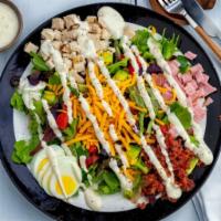 Cobb Salad · Baby greens, honey ham, grilled chicken, bacon, sliced hard boiled egg, olives, fresh tomato...