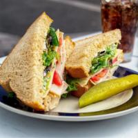 Turkey Deli Sandwich · Roasted turkey, mayo, baby greens, fresh tomatoes, and swiss cheese served cold on wheat bre...