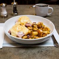 Classic Eggs Benedict · A toasted English muffin with slices of Virginia ham, plum tomatoes and two poached eggs, th...