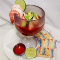 Coctel de Camarones · Shrimp cocktail marinated in tomato sauce and garnished with onions, cilantro and avocado.