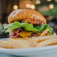 BBQ Burger · Angus beef, Pepper Jack cheese, onion rings, banana peppers, BBQ sauce on a Brioche bun