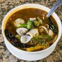 Spicy Seafood Noodle Soup · Sauteed calamari, clam, scallop, shrimp, broccoli, lettuce, green onion, white onion, snow p...