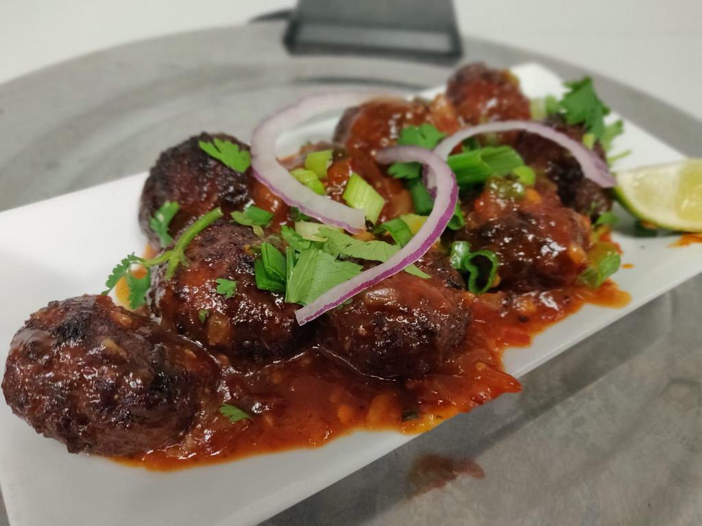 Mixed Vegetable Manchuria · Vegetable balls marinated in a spiced batter, deep fried and tossed in house made Manchurian sauce and finely minced ginger and garlic.