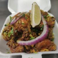Mirapakai Kodi Vepudu · Bone in chicken deep fried and tossed with green chilies, onions and Indian spices.