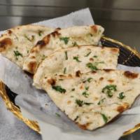Garlic Naan · Leavened bread made in tandoor oven is topped with minced garlic.