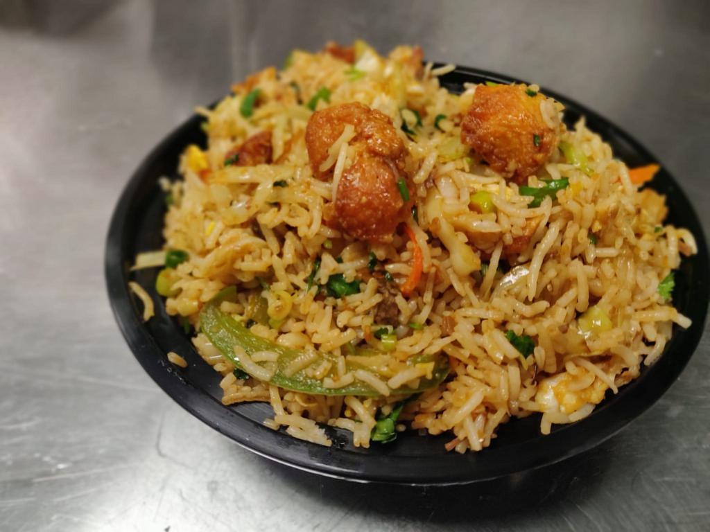 Chicken Fried Rice · Steamed rice stir fried on a wok along with chunks of chicken and freshly chopped vegetables and egg.
