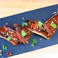 Sticky Thai BBQ Ribs · peanut sauce. pickled fresno chilies. crushed peanuts. cilantro.