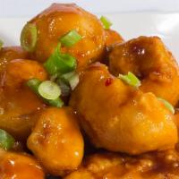 Orange Chicken · Hand cut and battered chicken bites smothered in sweet and tangy orange sauce with pineapple...
