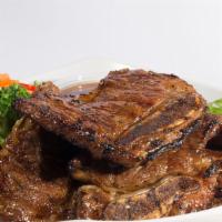 Korean Beef Short Ribs · Premium beef short ribs are marinated with a sweet-ginger soy sauce. Served with steam veggi...