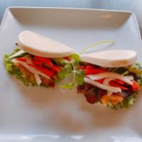 Grilled Meat Bao - banh bao · Bao stuffed with the choice of chicken, pork, or beef, and picked carrot daikon, cucumber, a...