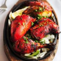 Chicken Tandoori · Chicken (with bones) marinated in yogurt and spices and grilled in a clay oven.
