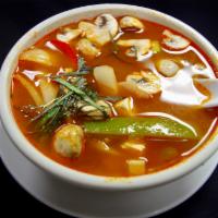 4. Tom Yum · Hot and sour chili broth cook with pepper, onion, mushroom and your choice of meat. Spicy.