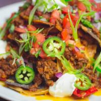 Nachos Grande · Beef, chicken or . Cheddar, sour cream, pico de gallo, black olives, jalapenos and scallions.