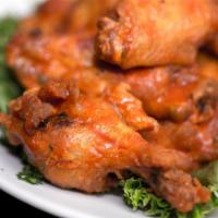 Jumbo Wings · Choice of Buffalo, dry rub, BBQ, or Thai chili. Served with bleu cheese, carrots, and celery.