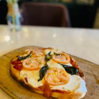 Margherita Flatbread · Flat unleavened bread usually topped with cheese, sauce, meats and veggies.