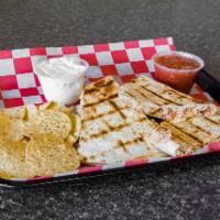 Quesadilla · Topped with homemade salsa and a blend of 3 cheeses. Served with nachos and a side of salsa ...