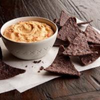 Blue Corn Chips & Hummus  · Order our hummus with chips and add zest to your meal! It’s made from mashed chickpeas, with...