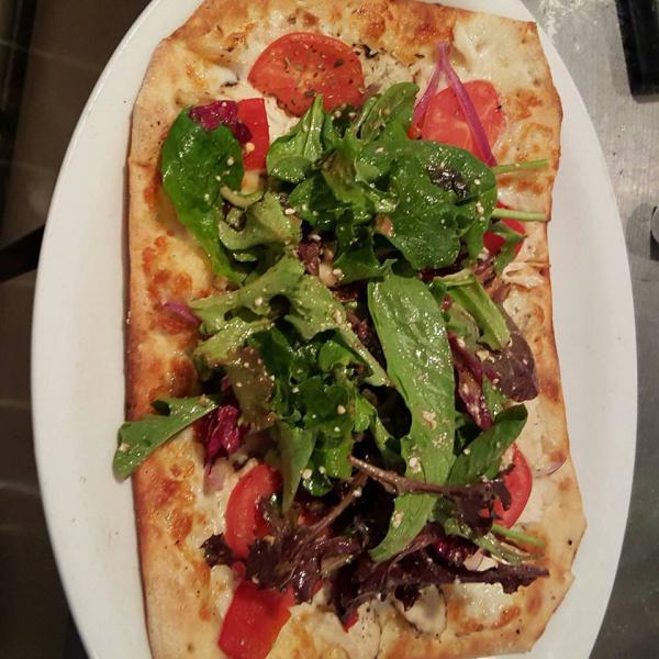 Peachtree Road Flatbread  · Grilled chicken breast sliced thin and topped with red onions, tomatoes, roasted red peppers, mozzarella cheese and mixed greens with balsamic and feta cheese. 