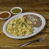 Migas · Scrambled eggs with tortilla chips, onions, tomatoes, peppers, cilantro and cheese on top.