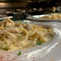Fettucine Alfredo  · Ribbon noodles with a blend of Parmesan cheese, cream and butter. Served with homemade garli...