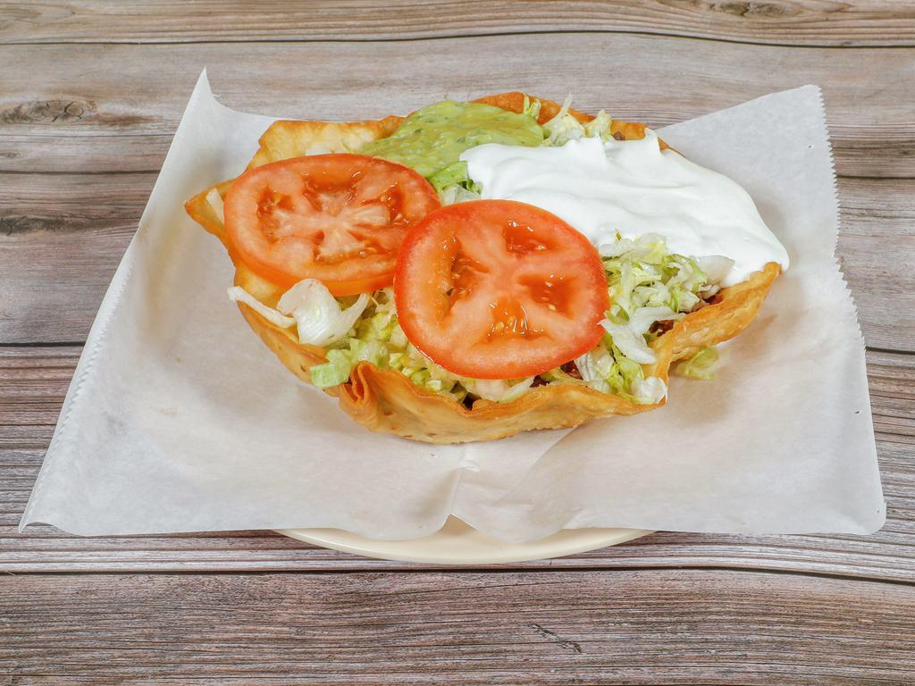 Taco Salad · Served with beans, cheese, sour cream, guacamole, tomatoes, and lettuce choice of meat.