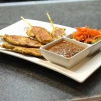 Chicken Satay · Grilled chicken breast skewers served with peanut sauce, and a cucumber salad cup.
