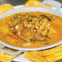 37. Mussmun Curry Short Ribs with Roti · Short ribs stewed overnight with sweet potatoes, shallot and peanut served with roti bread