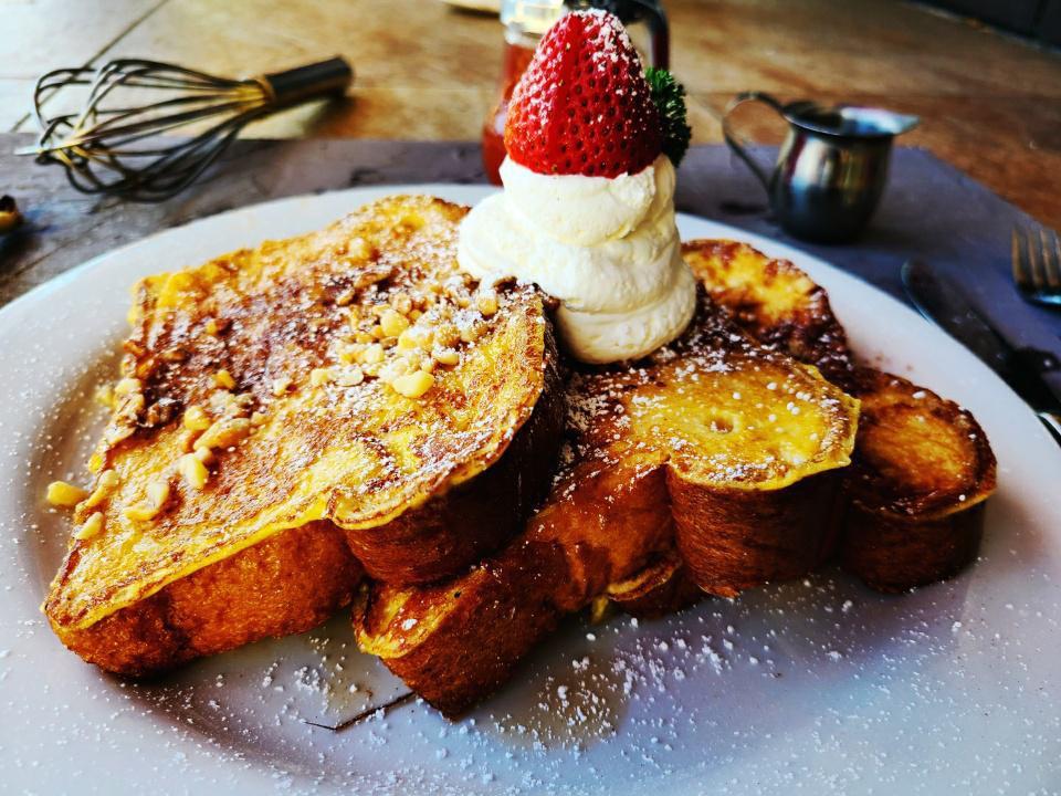 Lehua French Toast · Brown butter maple syrup, macadamia nuts, powder sugar, macadamia nuts, powder sugar.