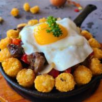 Breakfast Skillet · Tater tots, Portuguese sausage, spam, bell pepper, zucchini, onion, egg, brown gravy.