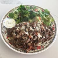 Beef Shawarma Plate · Slices of beef shawarma grilled with tomatoes served with tahini sauce, rice pilaf, salad, a...