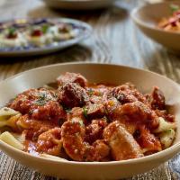 Nonna’s Sunday Gravy · Sweet italian sausage, meatballs, braciole, chicken thighs, slow simmered tomato gravy, riga...