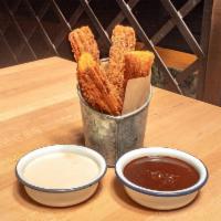 Churros · Served with 2 dipping sauces:  Mexican chocolate and dulce de leche whipped cream.
