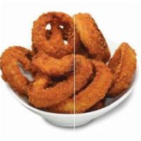Onion Rings · Thick slices of onions in a crunchy batter, served golden brown with a side of ketchup. Vege...