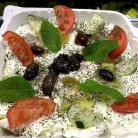Labneh · Drained yogurt, garnished with tomatoes, cucumbers, and Kalamata olives sprinkled with mint.