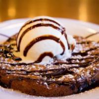 O's American Cookie · Our signature freshly baked cookie topped with vanilla bean ice cream with a choice of choco...