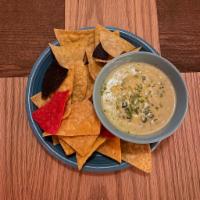 Rajas Con Crema · Melted coconut queso, shredded poblano peppers. Gluten Free. 