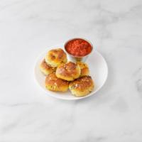 6 Garlic Knots · Served with sauce.