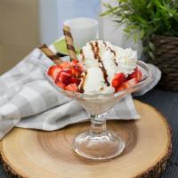 I02. Vanilla Strawberry Sundae with Chocolate Syrup · Vanilla ice cream with strawberries